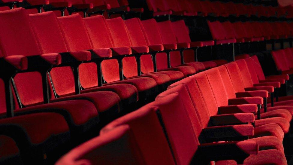 Red seats inside of a cinema, empty