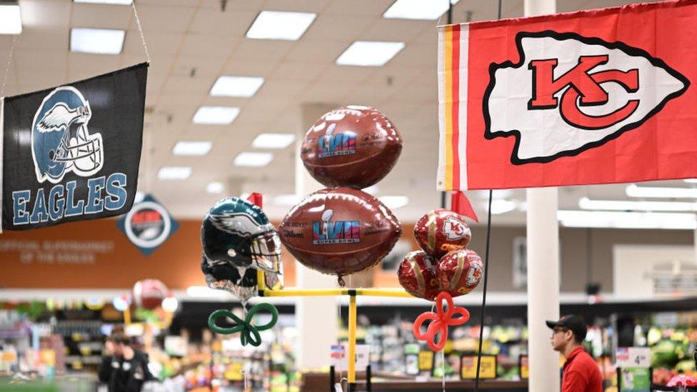 Philadelphia Eagles and Kansas City Chiefs banners and merchandise at a store in the United States.