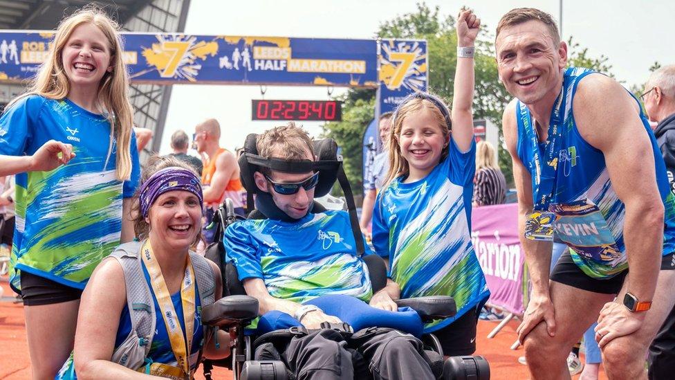 Kevin Sinfield (right) with Rob and Lindsey Burrow as well as their children