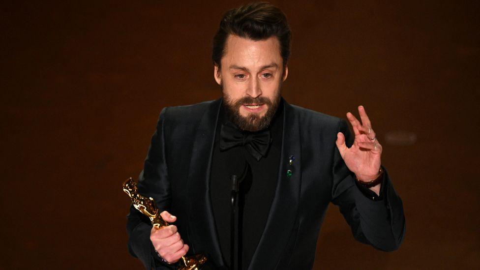 US actor Kieran Culkin accepts the award for Outstanding Performance by a Male Actor in a Supporting Role for "A Real Pain" onstage during the 97th Annual Academy Awards at the Dolby Theatre in Hollywood, California on March 2, 2025.