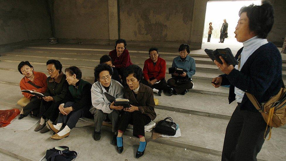 Ethnic Korean Christians sing hymns in their half-finished church in the town of Yanji in Yanbian Korean Autonomous Prefecture on the China/North Korea border