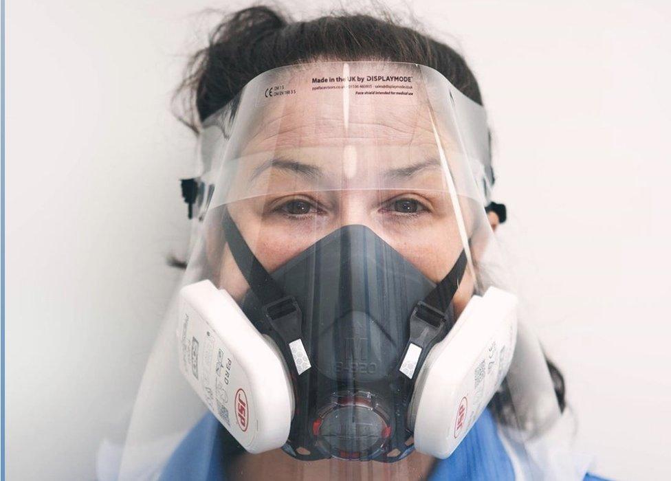 Jodie Bond, a community nurse in unplanned care at Norfolk Community Health and Care NHS Trust, wearing a face shield and respirator