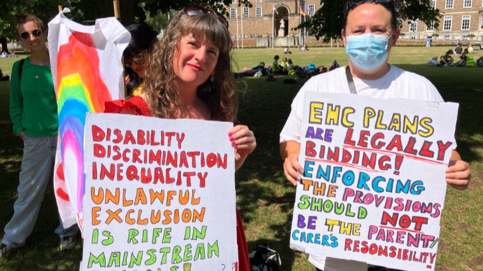 Zoe and a friend holding pickets at the protest