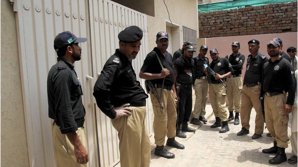 Pakistani policemen outside Qandeel Baloch's house following her murder