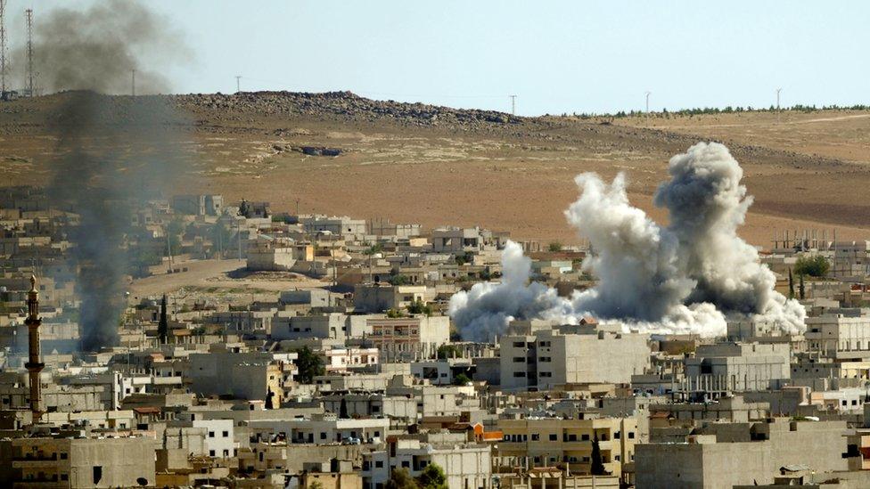 Smoke billow from the Syrian town of Kobane following an air strike by the U.-led coalition Kobane, Syria, on 21 October2014