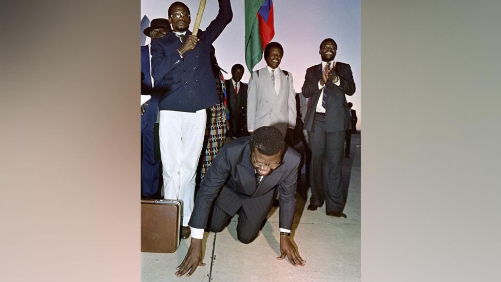 Hage Geingob kissing the ground