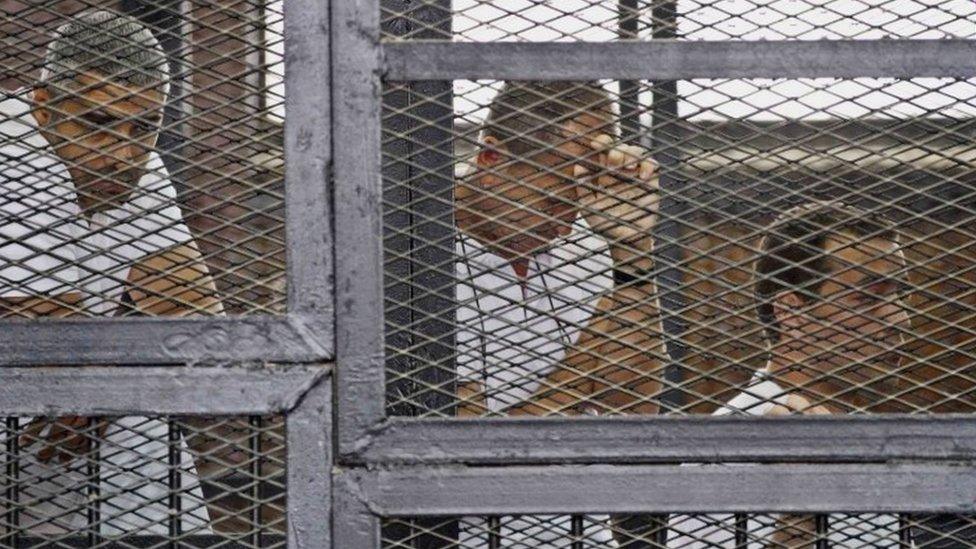 Mohammed Fahmy (left), Peter Greste (centre) and Baher Mohamed in court in Cairo (May 2014)