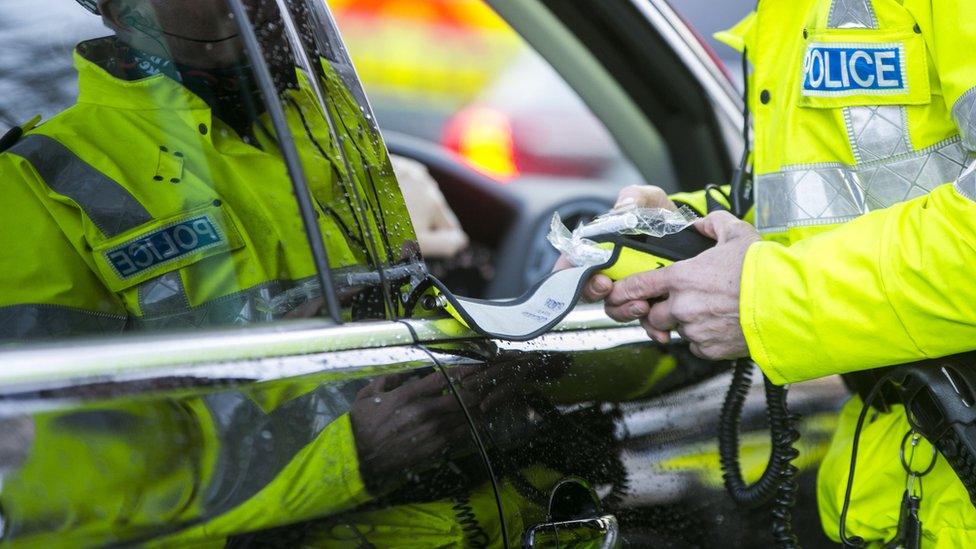 Police officer preparing a breathalyser test