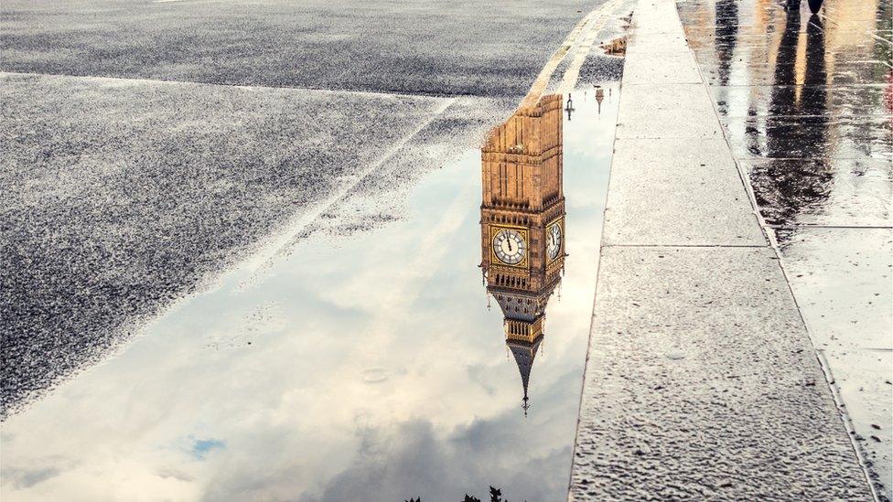 The Elizabeth Tower reflected in a puddle in London.