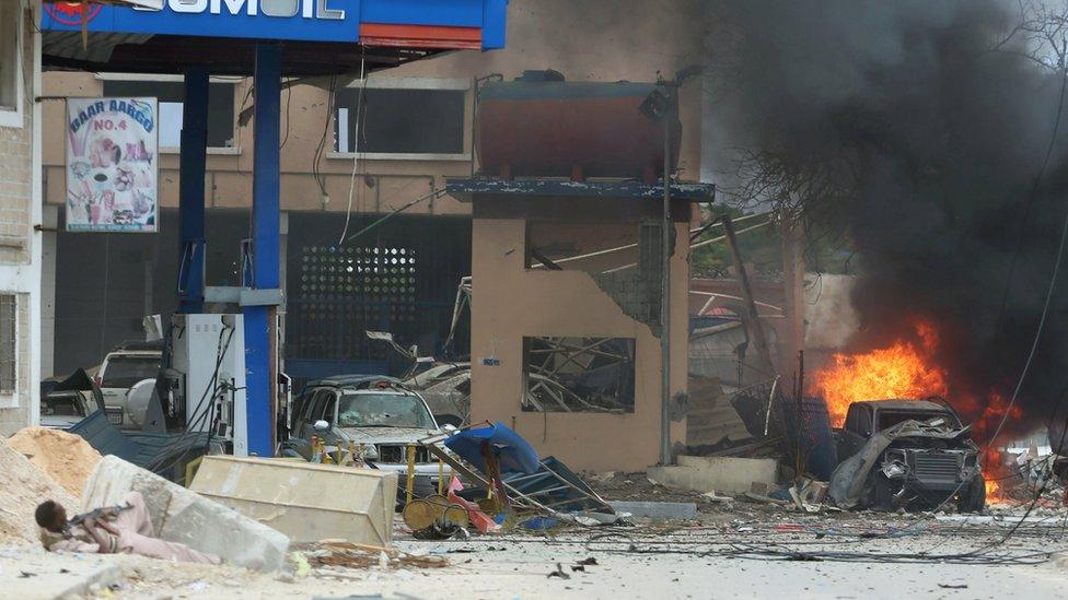 A Somali government soldier holds his position during gunfire after a suicide bomb attack outside a hotel in Somalia's capital Mogadishu, on 25 June