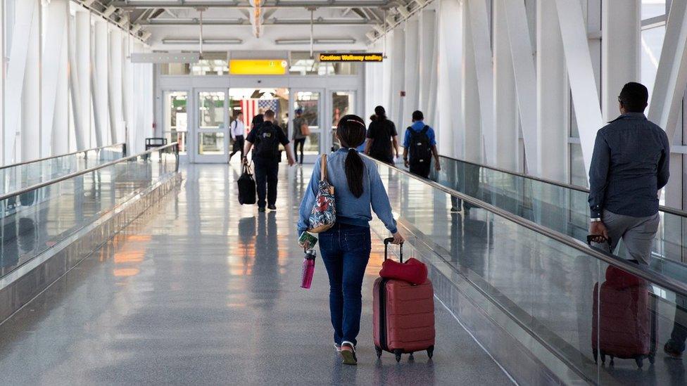 People head towards departures at John F Kennedy Airport in 2016