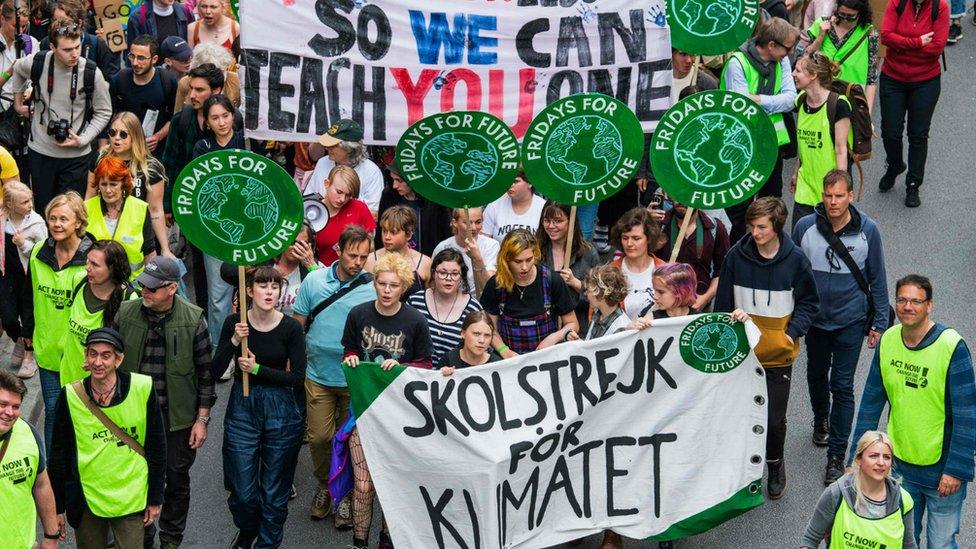 Greta Thunberg (c) leads people marching in Stockholm