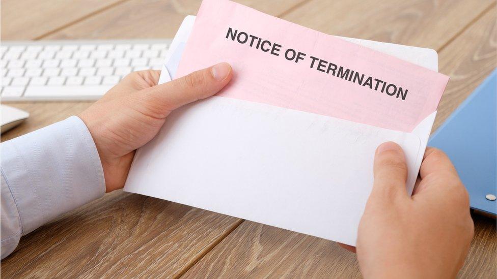 Fired business man reads the notice of job termination