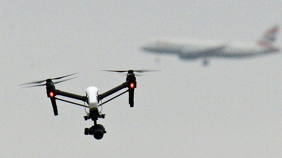 Drone flies in foreground as British Airways plane can be seen in the background