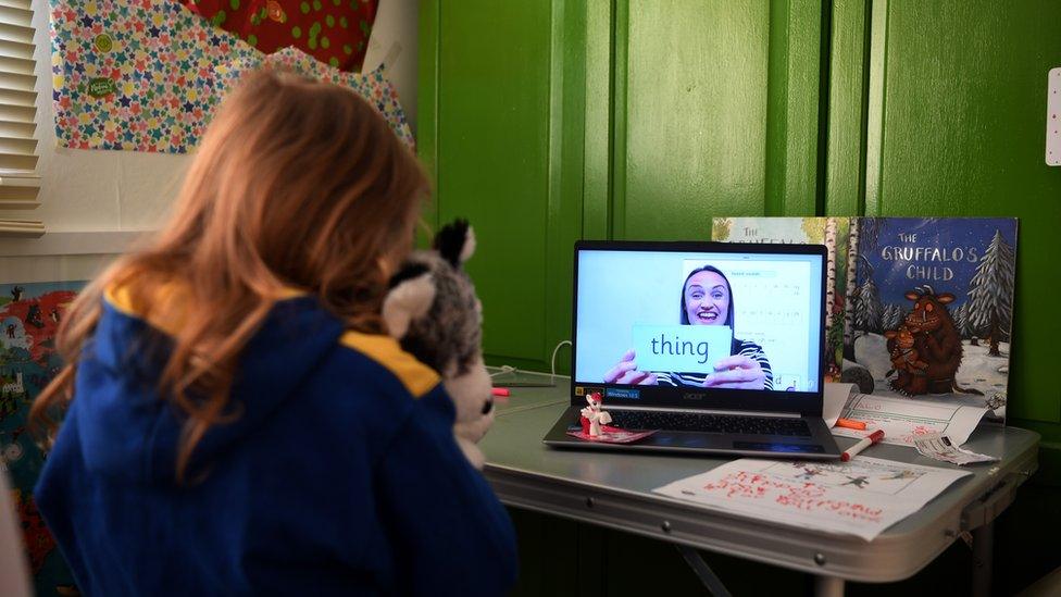 Schoolgirl takes part in an English lesson from home