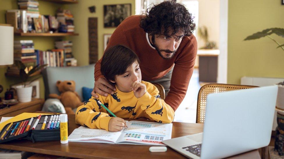 Father helping his son with schoolwork