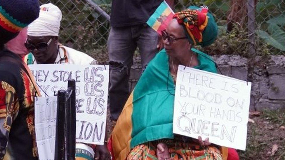 A small protest outside the Fond Doux Cocoa Plantation in Saint Lucia during the visit by the Earl and the Countess of Wessex, as they continue their visit to the Caribbean, to mark the Queen"s Platinum Jubilee