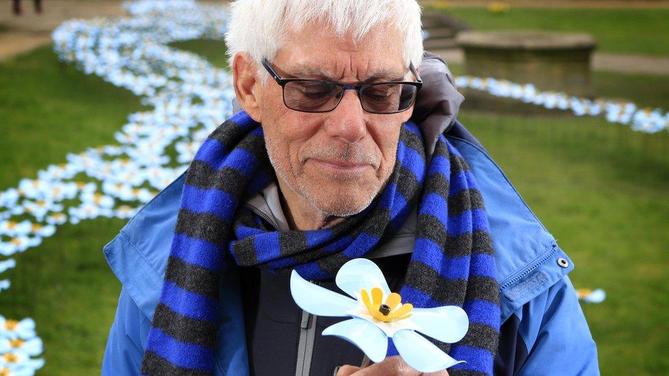 Brian Ratcliffe, hospice volunteer and trustee, with the flower sculpture he has bought