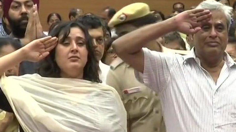 Swaraj's daughter, Bansuri Swaraj (L) , and her husband Swaraj Kaushal salute her as state honours are accorded.