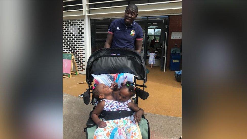 Ibrahima laughing with his children at their Cardiff playgroup