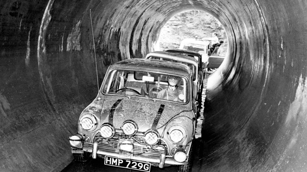 Shot from The Italian Job, showing minis driving through large sewer pipes in coventry