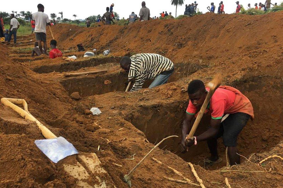 Men digging graves