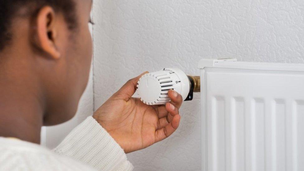 Woman adjusting a radiator