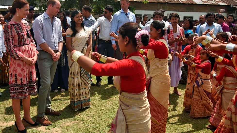 Prince William and his wife Catherine, the Duchess of Cambridge, watch a traditional dance in Panbari village in Kaziranga