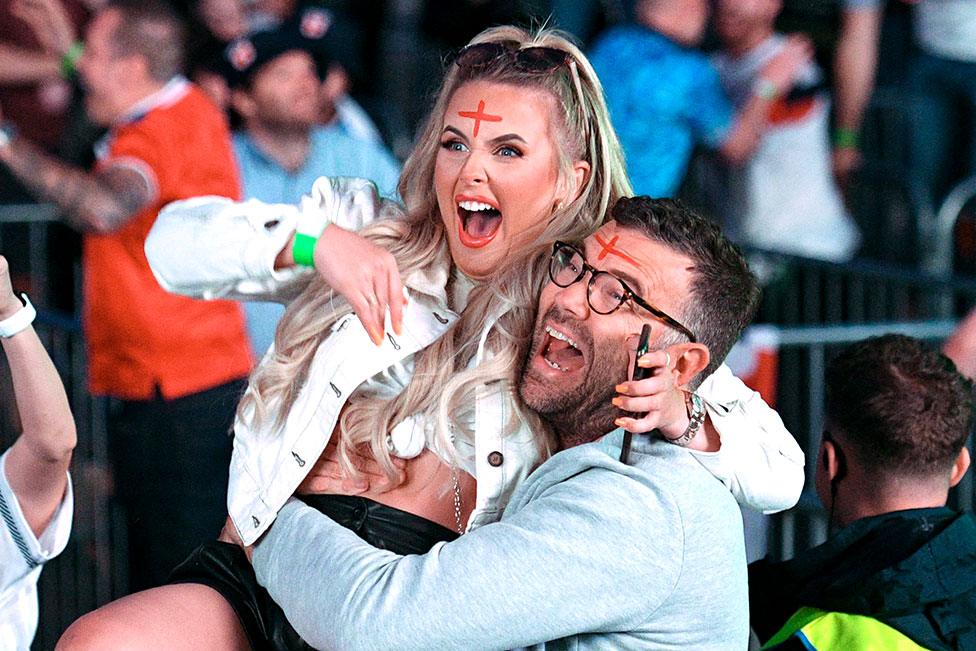 England supporters celebrate England's penalty and second goal as they watch the UEFA EURO 2020 semi-final football match between England and Denmark