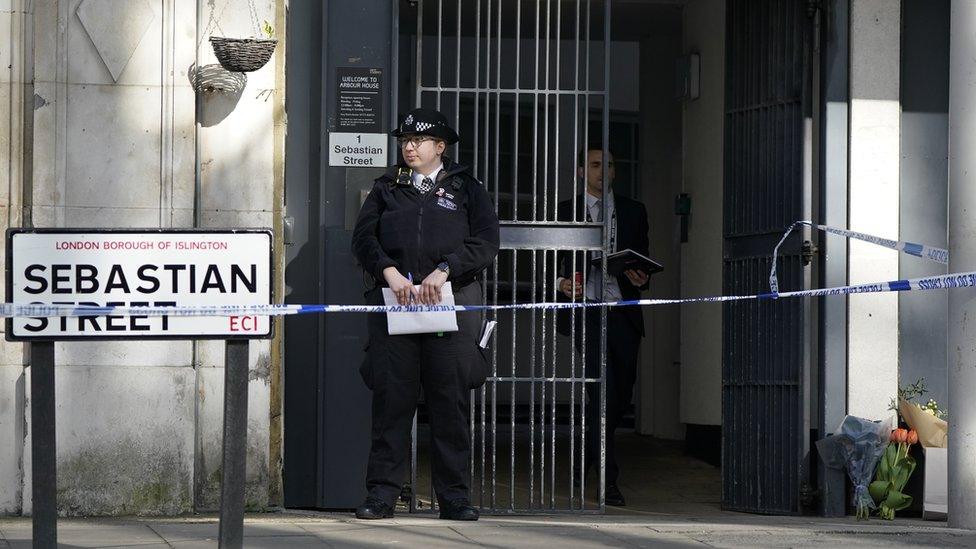 Flowers laid at police cordon at Arbour House