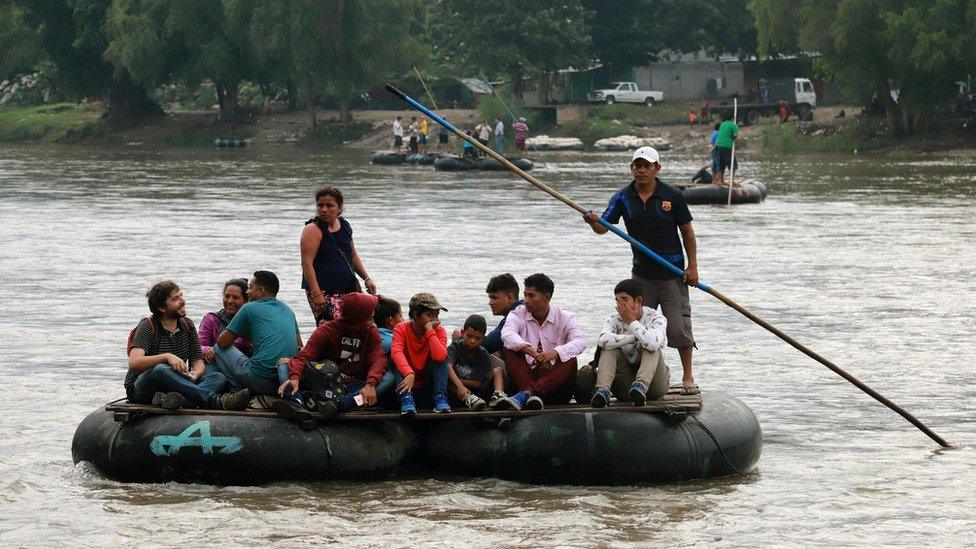 Locals and Central American migrants use a makeshift raft across the Suchiate river from Tecun Uman in Guatemala, to Ciudad Hidalgo in Chiapas State, Mexico, on June 11, 2019