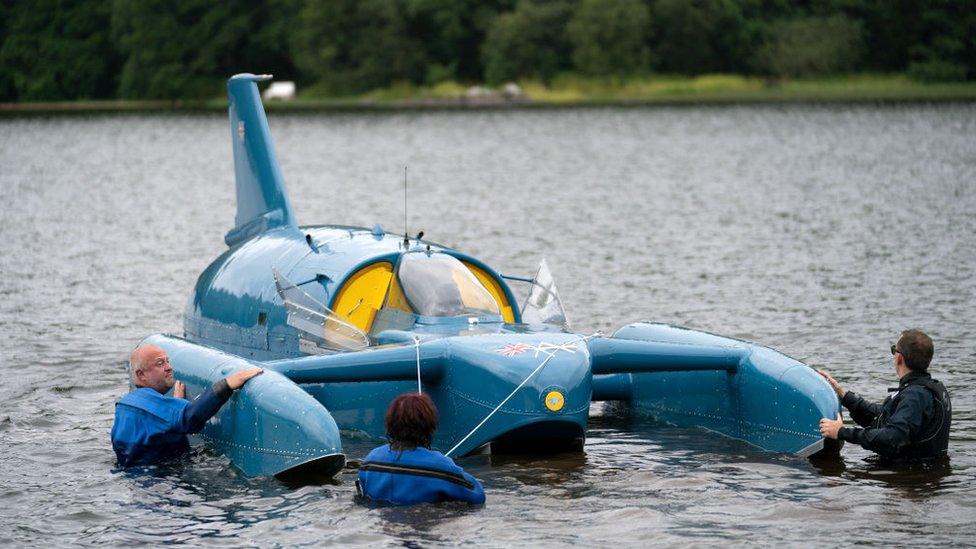 Bill Smith (left) in the water with Bluebird at Loch Fad in 2018