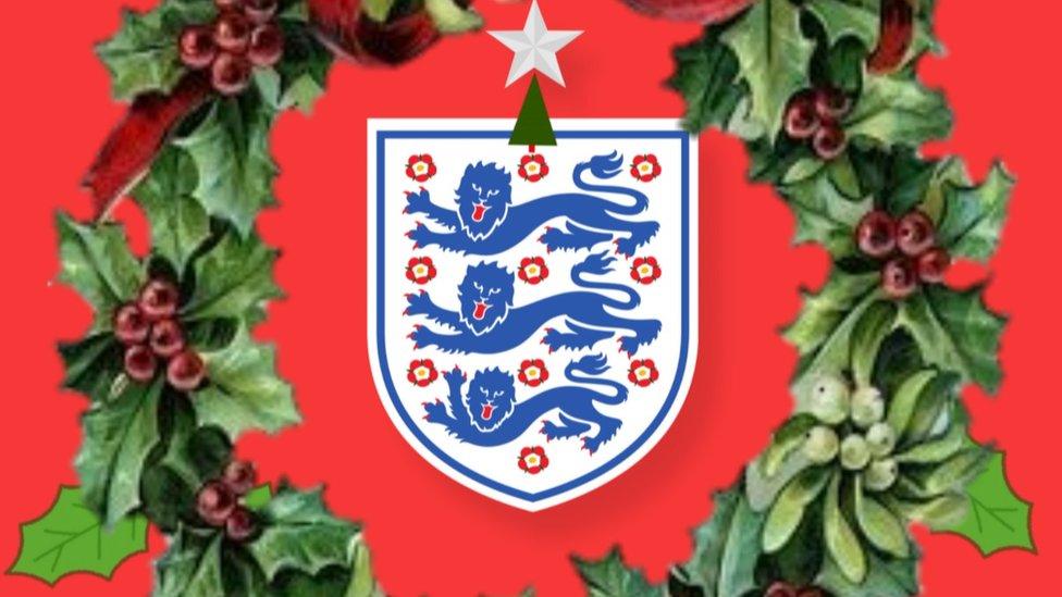 Three lions badge surrounded by a Christmas wreath.