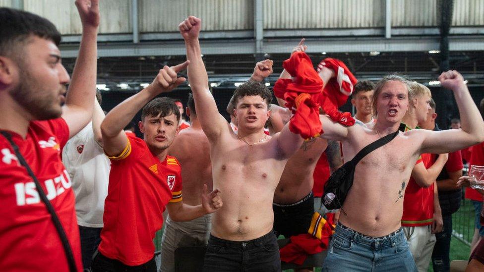 Football fans react as they watch Wales v Turkey on 16 June 2021 in Penarth, Wales.