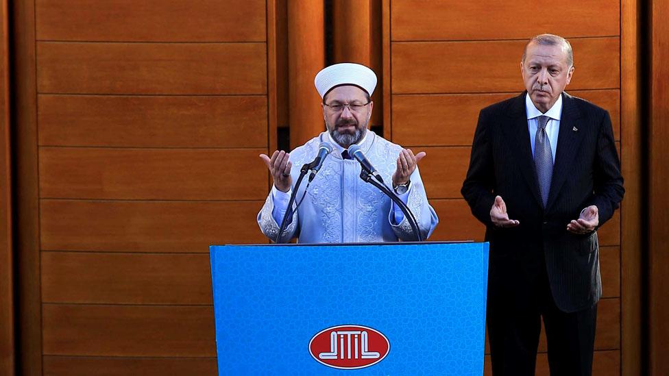 Turkish President Recep Tayyip Erdogan (R) stands next to the President of Religious Affairs of Turkey Ali Erbas