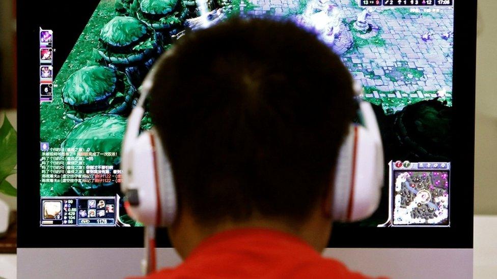 Chinese man playing computer game