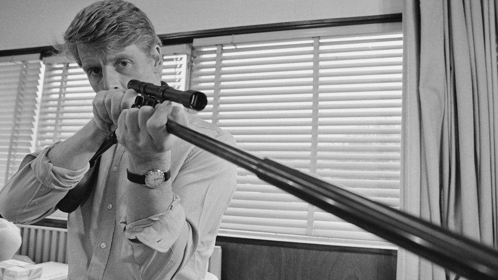 Edward Fox in The Day of the Jackal. He is looking into the sights of his rifle.