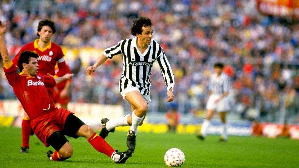 Sebastiano Nela (left) of Roma AS tackles Michel Platini of Juventus during a match at the Delle Alpi Stadium in Turin, Italy