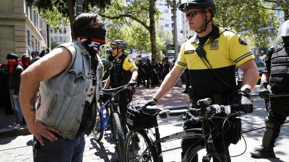 Police facing off with a protester