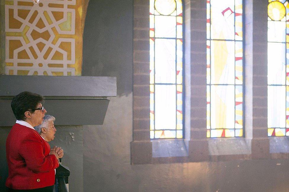 People praying inside a church