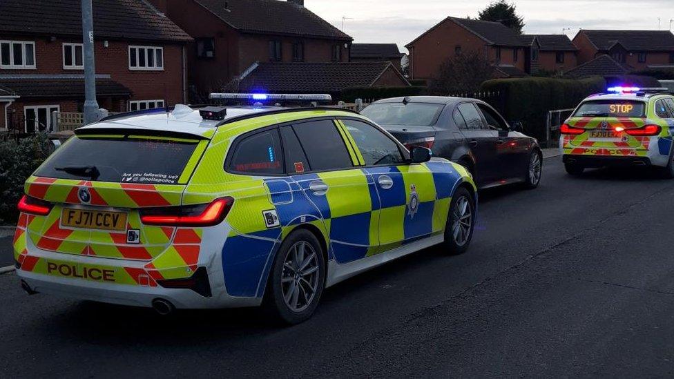 Police cars with stopped car