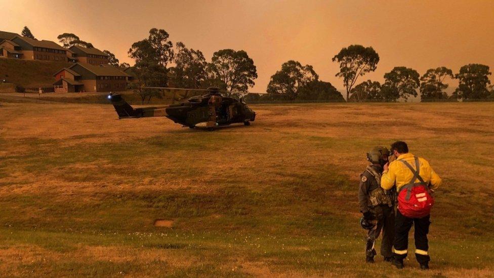 A helicopter on the field of a residential area in Victoria