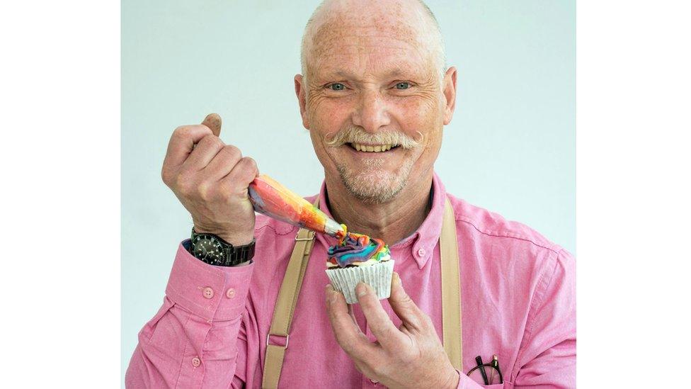 Terry ices a rainbow cupcake