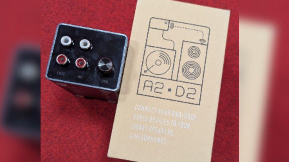 The A2-D2 grey box with connecting plugs showing and the A2-D2 instruction manual