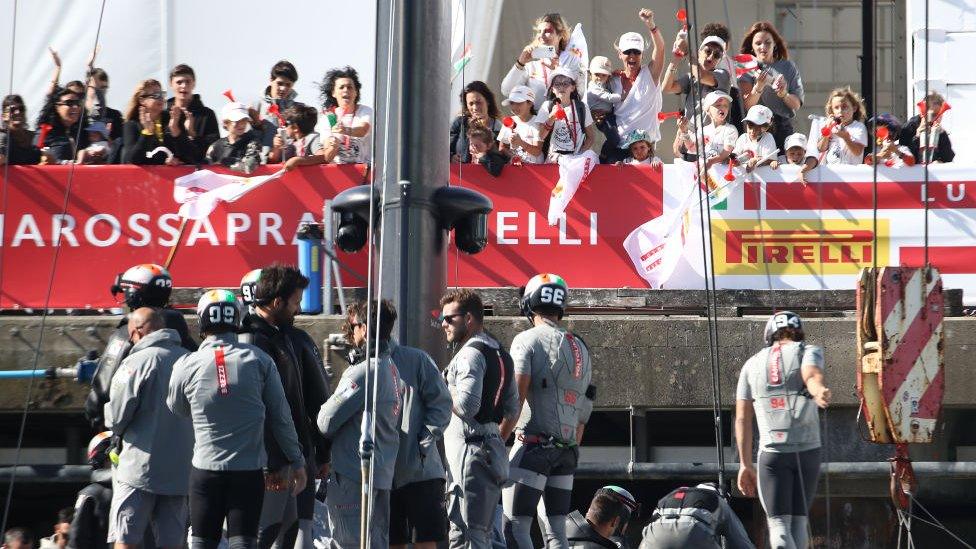 Fans watch a boat race