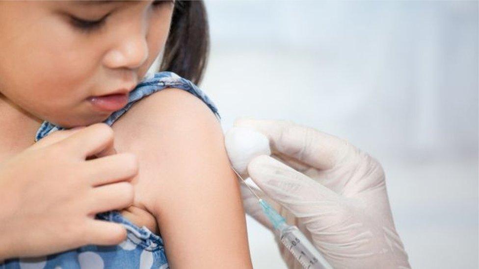 girl getting vaccine