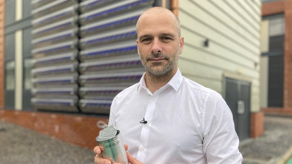 Prof Pleydell-Pearce holding an empty can