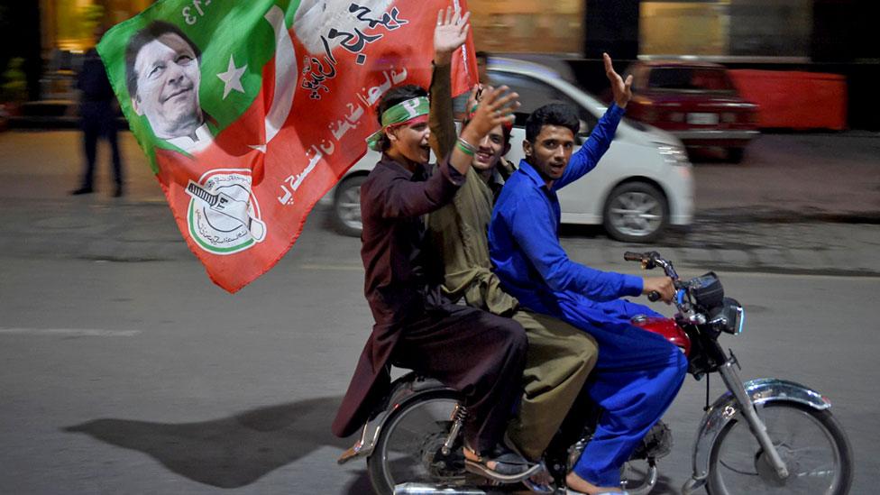 Supporters of Pakistan's cricketer-turned politician Imran Khan, celebrate in Rawalpindi, 25 July 2018