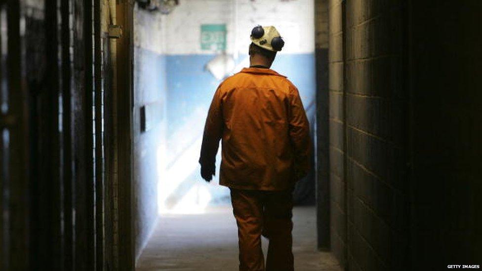 A coal miner at Hatfield Colliery in 2006, seen from behind as he walks into the distance