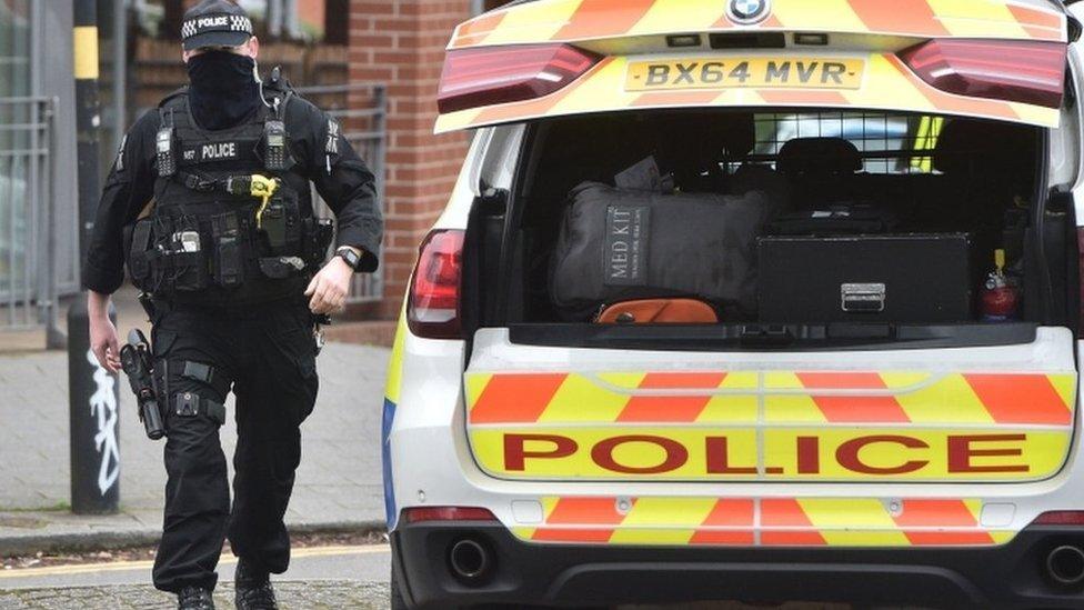 A firearms officer walks to his vehicle